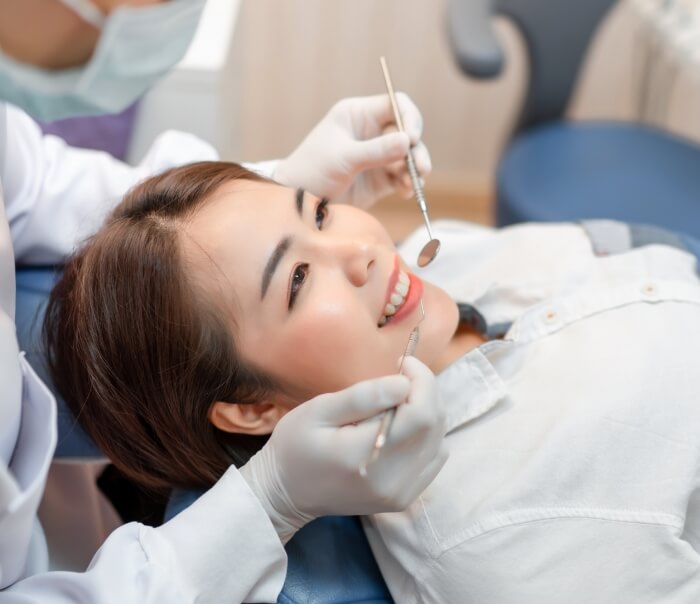 Woman smiling during checkup at dental office in Santa Fe