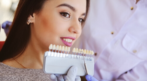 Woman in dental chair trying on veneers