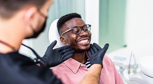 Man with beautiful teeth smiling with dentist